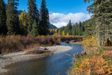 River flowing through mountainous valley in autumn