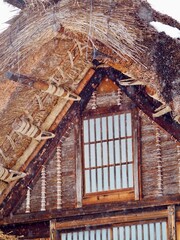 Traditional Gassho-style thatched roof house in Shirakawa-go, Japan, covered in snow during winter.