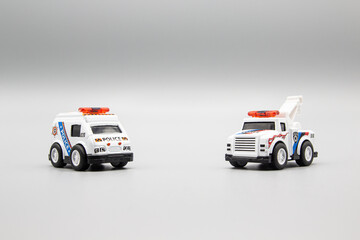 Two small toys: tow truck and a police car © scar