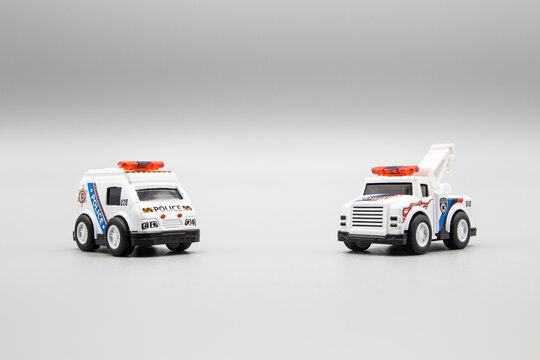 Two small toys: tow truck and a police car