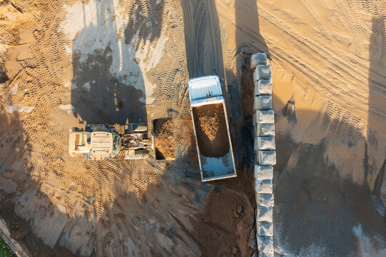 Aerial view of sand quarry with loader and dump truck