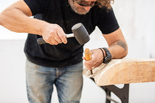 Carpenter using handtool