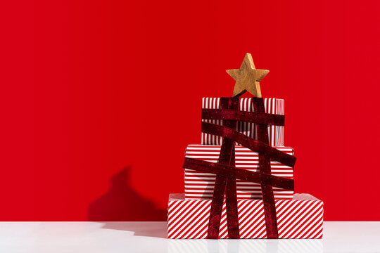 Pile of gift boxes arranged as Christmas tree