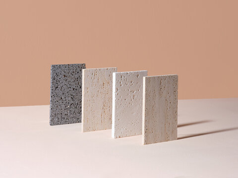 Artistic arrangement of various textured tiles on a neutral background