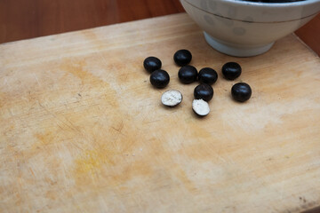 Ball biscuit wafer with chocolate coating on white bowl in the wooden cutting board. sweet snack