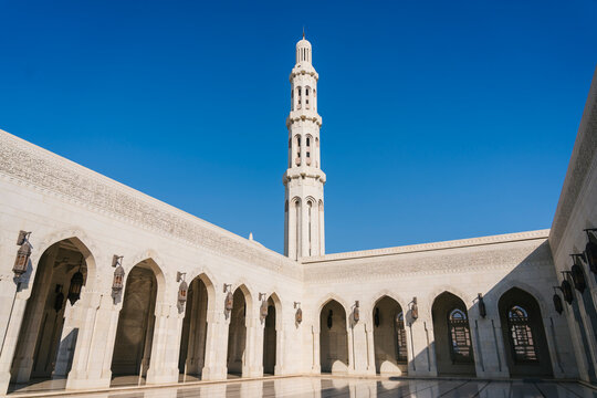 Minaret towering over sultan qaboos grand mosque in muscat, oman