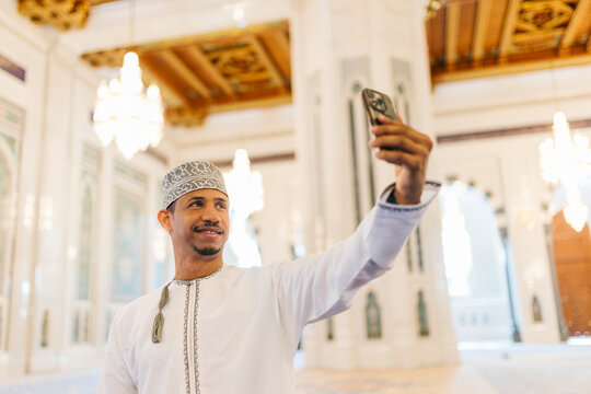 Omani man taking selfie in sultan qaboos grand mosque