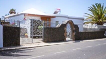 Obraz premium Blurred view of a modern house in lanzarote, spain with defocused outdoor scenery and bokeh effect