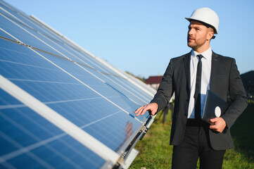 The solar farm, solar panel with engineer check the operation of the system, Alternative energy