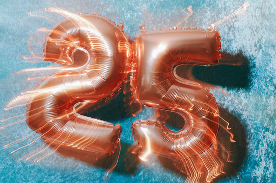 motion blur of pink balloons forming number 25