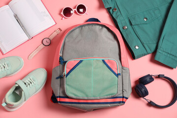 Stylish outfit with backpack on pink background, flat lay