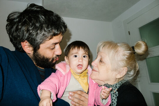 UGC Father and grandmother admiring baby girl at home, Selfie
