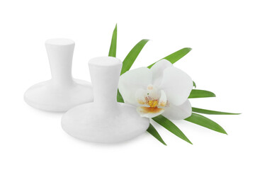 Spa stones, green palm leaf and orchid flower isolated on white