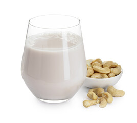 Fresh cashew milk in glass and nuts isolated on white