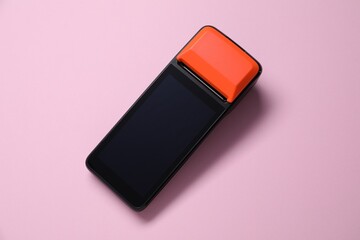 One payment terminal on pink background, top view