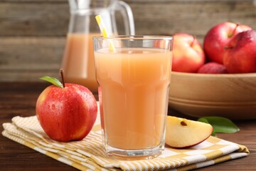 Tasty apple juice and fresh fruits on wooden table, closeup