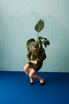 Unique Conceptual Photography of Person Holding Large Plant