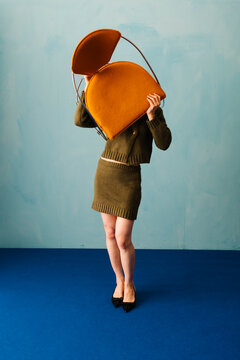 Creative Fashion Concept With Bold Style and Chair Interplay