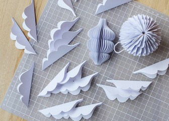 Diy paper ornaments in various design scattered on crafting mat