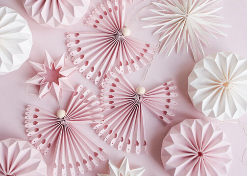 Reusable paper baubles in form of stars and angels in studio