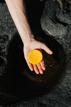 Female hand holding an organic solid gel bar for atopic skin