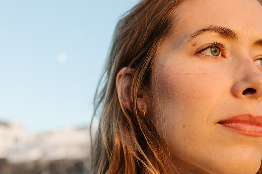 Close-up portrait of a young woman, posing with a cheerful countenance