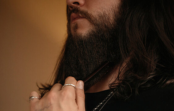 anonymous man comb his beard