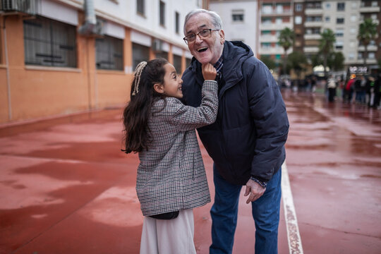 grandfather and granddaughter having fun outdoors