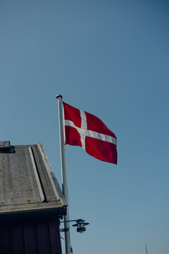 Danish flag waving proudly against a clear blue sky