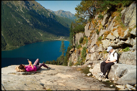People on top with phones in beautiful mountains