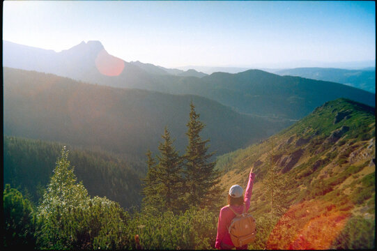 A man on a mountain hike points the direction