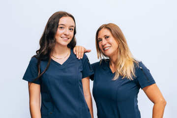 Confident healthcare personnel in blue uniforms smiling