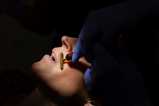 Patient Receiving Facial Treatment with Vibrating Tool