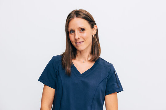 Confident Female Medical Professional in Blue Scrubs