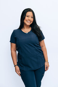 Health professional smiling in blue uniform on white background