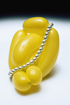 Pearls on yellow balloon.