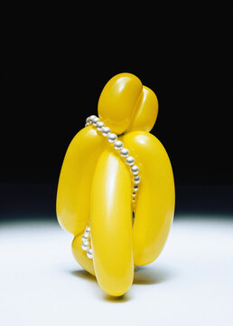 Pearls on yellow balloon.