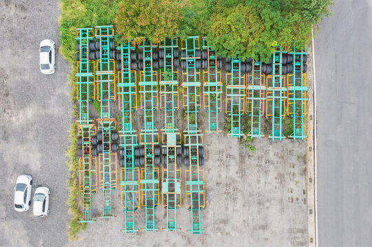 Aerial view of neatly arranged semi trailer frames with tires