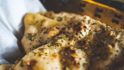 Delicious oily naan bread indian bread cuisine close up