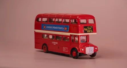 Fototapete Rund London double decker bus model. Famous vintage london bus model toy golden view. Iconic Bus © John Louie Photos