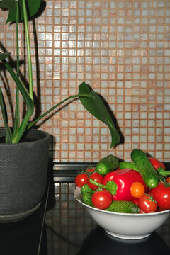Bowl with fresh vegetables on a kitchen countertop. 