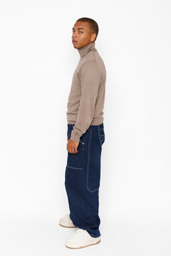 Man wearing a turtleneck sweater and baggy jeans 