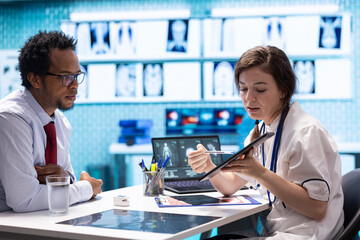 Medical staff reviewing diagnostic reports and results for a patient, focusing on x ray imaging and...