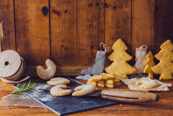 christmas cookies and decorations on a rustic wooden table