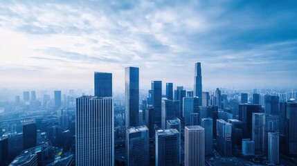 Fototapeta premium Scenic View of Modern Skyscrapers Under a Dramatic Blue Sky in a Bustling Urban Landscape