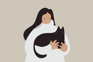 Young woman holding a black cat