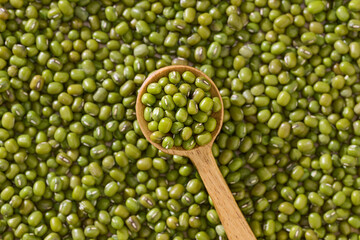 Green Mung Beans In Wooden Spoon On mungs Background