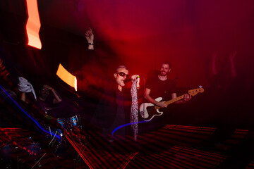 Energetic live band performance with vibrant lighting effects