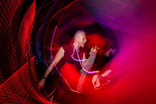 Dynamic live performance with vibrant red and purple lighting