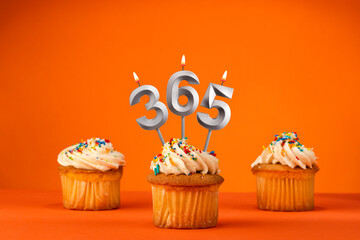 Number 365 in the form of candles on a orange background.